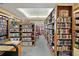 Well-stocked community library with rows of wooden shelves and a cozy seating area near the window at 6419 Borg St, Leesburg, FL 34748