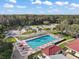 Aerial view of community pool with lounge chairs, umbrellas, and meticulously landscaped grounds at 6419 Borg St, Leesburg, FL 34748