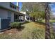 Scenic backyard with a tranquil pond, lush green grass, and inviting screened porch at 115 Lake Emma Cove Dr # 1, Lake Mary, FL 32746