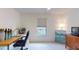 Bright bedroom featuring neutral carpet, desk, and natural light from the window at 115 Lake Emma Cove Dr # 1, Lake Mary, FL 32746