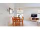 Open dining area with wood table set for six, carpet, and a window with natural light at 115 Lake Emma Cove Dr # 1, Lake Mary, FL 32746