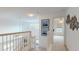 Bright upstairs hallway with natural light, carpet, and decorative wall art at 115 Lake Emma Cove Dr # 1, Lake Mary, FL 32746