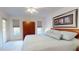 Comfortable main bedroom featuring a king bed, a ceiling fan, and natural light at 115 Lake Emma Cove Dr # 1, Lake Mary, FL 32746