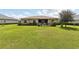 Large backyard with green lawn and a partial view of house at 38905 Harborwoods Pl, Lady Lake, FL 32159