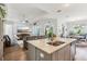 Open concept kitchen with island and view of living room at 38905 Harborwoods Pl, Lady Lake, FL 32159