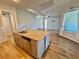 Kitchen island with granite countertop and stainless steel sink at 38905 Harborwoods Pl, Lady Lake, FL 32159