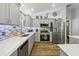 Modern kitchen with stainless steel appliances and gray cabinets at 1101 Blythe Way, The Villages, FL 32162