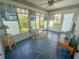 Relaxing sunroom with view of backyard and seating area at 1101 Blythe Way, The Villages, FL 32162