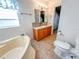 Clean bathroom with a bathtub, toilet and vanity at 1660 Elkhart Cir, Tavares, FL 32778