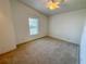 Well-lit bedroom with carpeted floor and window at 1660 Elkhart Cir, Tavares, FL 32778