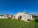 Home's exterior with shed and grassy yard at 1660 Elkhart Cir, Tavares, FL 32778