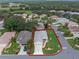 An aerial view showcasing a single Gathering home and its landscaping at 21835 King Henry Ave, Leesburg, FL 34748