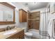 Bathroom features a shower/tub combo and wood vanity at 21835 King Henry Ave, Leesburg, FL 34748