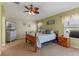 Bright bedroom featuring a wood bed frame and large windows at 21835 King Henry Ave, Leesburg, FL 34748