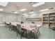 Community room with long table, chairs, and storage cabinets at 21835 King Henry Ave, Leesburg, FL 34748