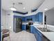 Stylish kitchen with blue cabinets and stainless steel appliances at 21835 King Henry Ave, Leesburg, FL 34748