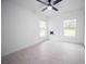 Bright bedroom with two windows, ceiling fan and wood-look tile flooring at 2482 County Road 423, Lake Panasoffkee, FL 33538