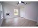 Light-filled bedroom featuring a ceiling fan, closet, and modern tile flooring at 2482 County Road 423, Lake Panasoffkee, FL 33538