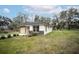 Expansive lawn wraps this newly renovated home with neutral tones and a modern aesthetic at 2482 County Road 423, Lake Panasoffkee, FL 33538