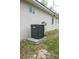 Exterior view of home with AC unit, electrical box and window at 2482 County Road 423, Lake Panasoffkee, FL 33538