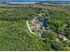 Birds-eye view of a waterfront community with lush vegetation at 28432 Tammi Dr, Tavares, FL 32778