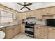 Galley kitchen with wood cabinets and stainless steel appliances at 28432 Tammi Dr, Tavares, FL 32778