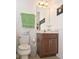 Compact bathroom with a toilet, a vanity with a small sink, and tiled floors at 436 Orange Cosmos Blvd, Davenport, FL 33837