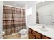 Bathroom with a vanity, a mirror, a toilet, and a shower with a patterned curtain at 436 Orange Cosmos Blvd, Davenport, FL 33837