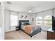 Comfortable bedroom features a bed, a TV, and multiple windows providing natural light at 436 Orange Cosmos Blvd, Davenport, FL 33837