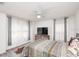Bright bedroom with a large TV, dresser, and comfortable bed, complemented by sheer curtains at 436 Orange Cosmos Blvd, Davenport, FL 33837