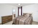 Relaxing bedroom with a bed, a dresser, and an ensuite bathroom at 436 Orange Cosmos Blvd, Davenport, FL 33837