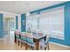 Bright dining room with a modern light fixture and seating for eight at 436 Orange Cosmos Blvd, Davenport, FL 33837