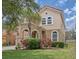 Charming two-story home featuring a clay tile roof, arched entry, and well-maintained landscaping at 436 Orange Cosmos Blvd, Davenport, FL 33837