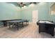 Spacious game room with ping pong table, shuffleboard, and air hockey for indoor entertainment at 436 Orange Cosmos Blvd, Davenport, FL 33837