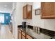 Open concept kitchen featuring dark granite countertops and wood cabinets at 436 Orange Cosmos Blvd, Davenport, FL 33837