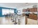 Modern kitchen with dark wood cabinets, granite countertops, stainless steel appliances and seating area at 436 Orange Cosmos Blvd, Davenport, FL 33837