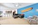 Spacious living area with a surfboard accent wall and tile flooring at 436 Orange Cosmos Blvd, Davenport, FL 33837
