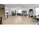 Spacious living room with tile floors, large windows, and a staircase, perfect for entertaining at 436 Orange Cosmos Blvd, Davenport, FL 33837
