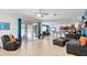 Open-concept living room with tile flooring and access to the patio/pool area at 436 Orange Cosmos Blvd, Davenport, FL 33837