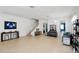 Open-concept living room with tile floors, natural light, and staircase with a modern feel at 436 Orange Cosmos Blvd, Davenport, FL 33837