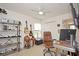 Comfortable office features a desk, guitars, and a ceiling fan; ideal for work or hobbies at 436 Orange Cosmos Blvd, Davenport, FL 33837
