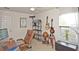 Bright office with a workstation, guitars, and a window with natural light at 436 Orange Cosmos Blvd, Davenport, FL 33837
