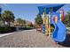 Community playground area featuring a slide, covered play structure, and soft ground covering at 436 Orange Cosmos Blvd, Davenport, FL 33837