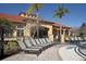 Community pool and clubhouse with lounge chairs offering a relaxing outdoor space at 436 Orange Cosmos Blvd, Davenport, FL 33837
