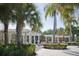 Resort-style pool area with lounge chairs, cabanas, and lush landscaping with tropical palms at 436 Orange Cosmos Blvd, Davenport, FL 33837