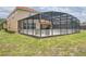 Enclosed pool area surrounded by green grass, providing privacy and a relaxing outdoor space at 436 Orange Cosmos Blvd, Davenport, FL 33837