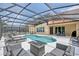 Enjoy the outdoors in this screened-in pool with patio furniture and clear blue water at 436 Orange Cosmos Blvd, Davenport, FL 33837