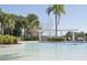 Inviting pool area with palm trees and shaded lounge areas offers a serene community amenity at 436 Orange Cosmos Blvd, Davenport, FL 33837