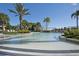 Large, inviting community pool surrounded by palm trees, lounge areas, and beautiful landscaping at 436 Orange Cosmos Blvd, Davenport, FL 33837