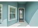 Modern entryway with glass front door and welcome mat at 6042 Claystone Way, Mount Dora, FL 32757